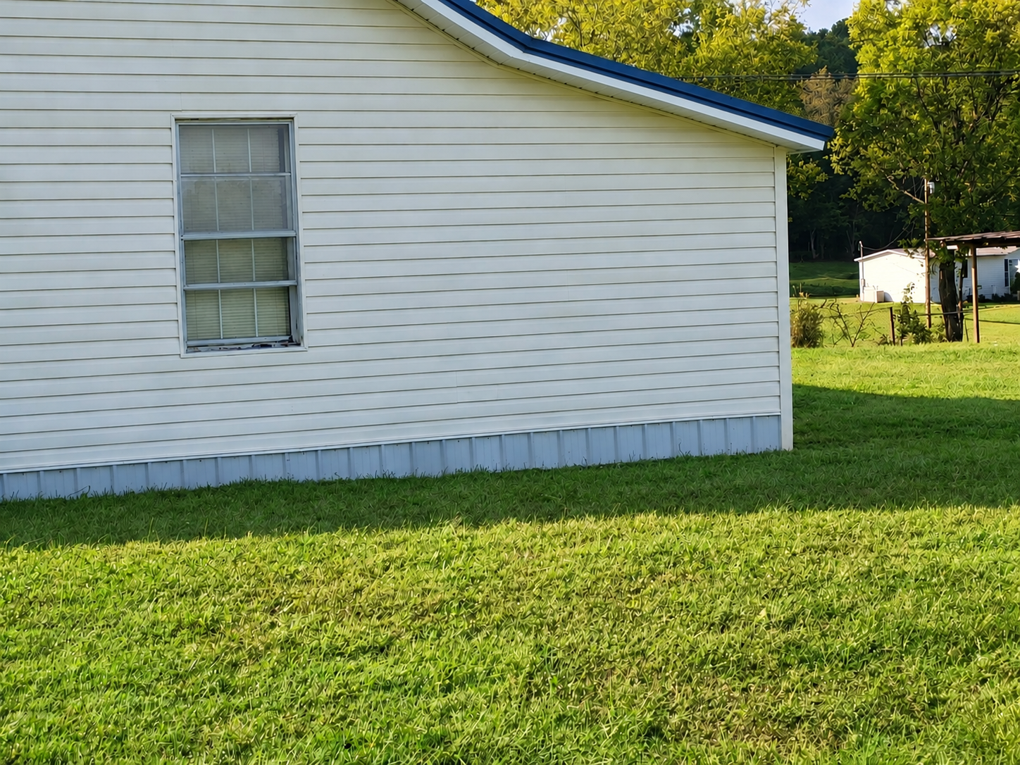 Exterior view showing the new cameo vinyl siding and metal skirting