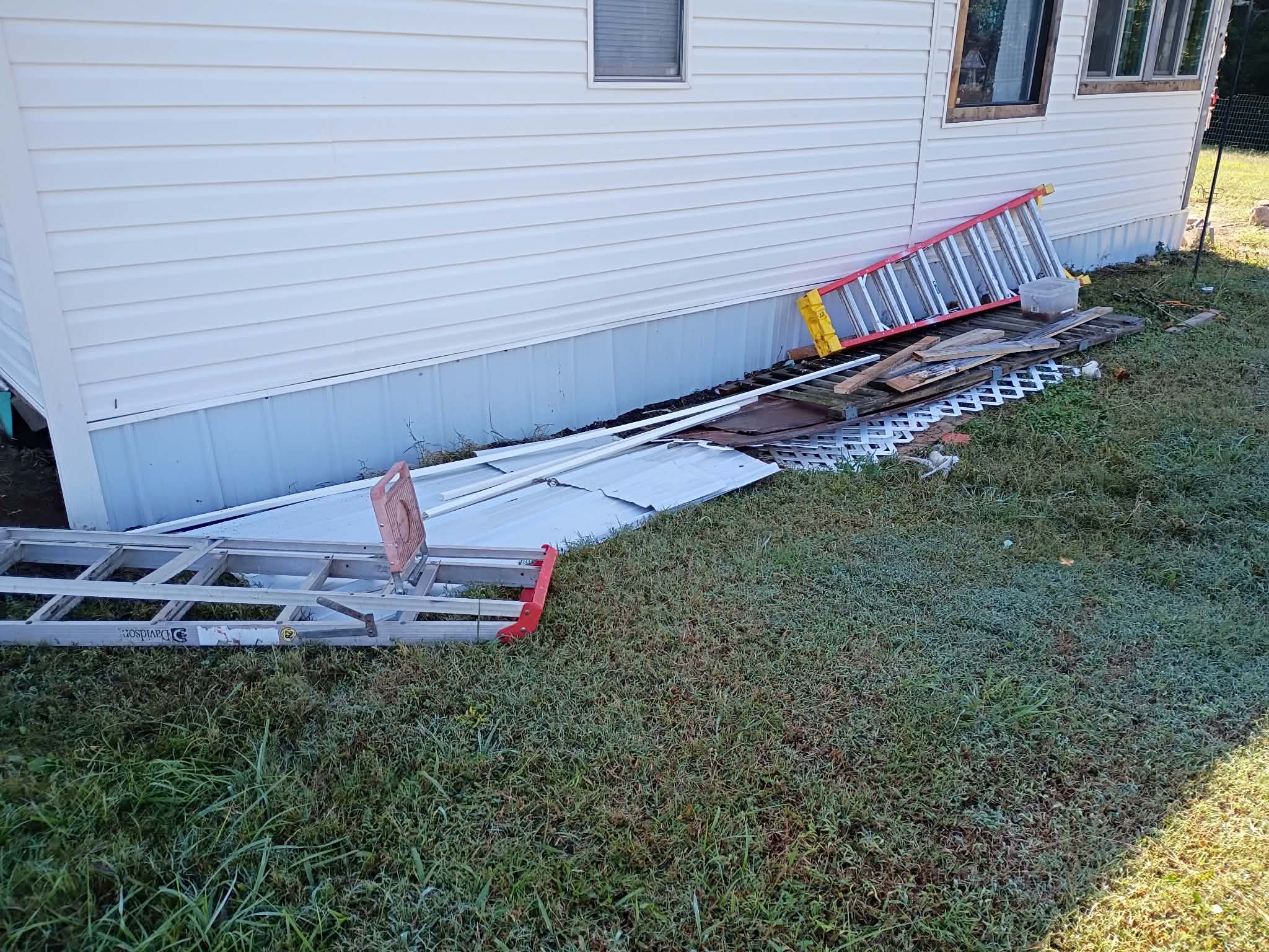 Completed white exterior siding and metal skirting